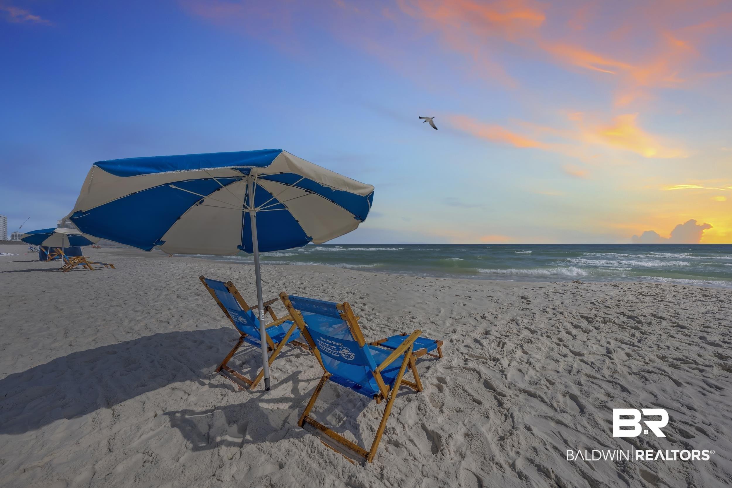 Image 4: Beachfront setting featuring white sand, ocean waves, and a wide-open sky