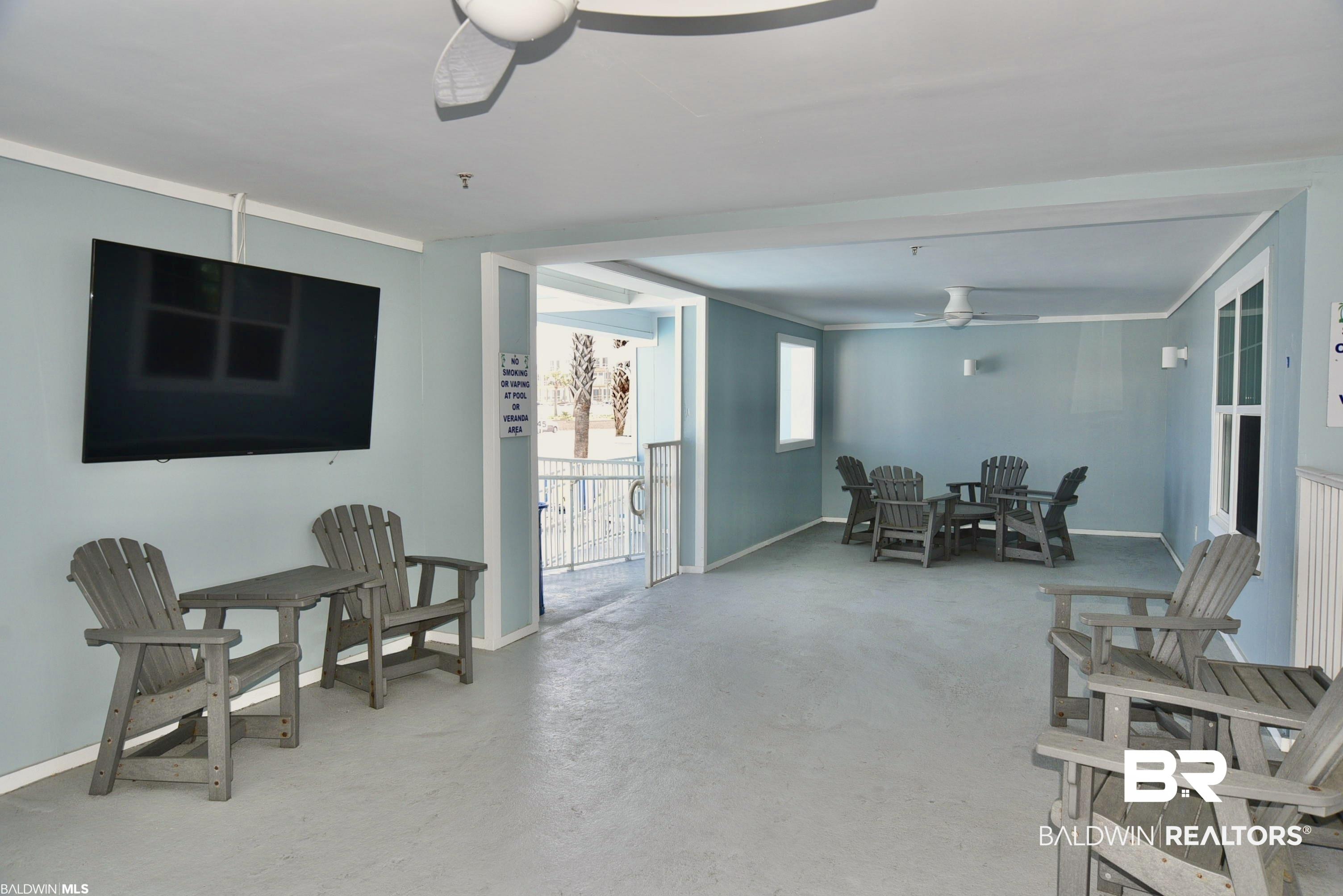 Image 3: Living room with ceiling fan and concrete floors