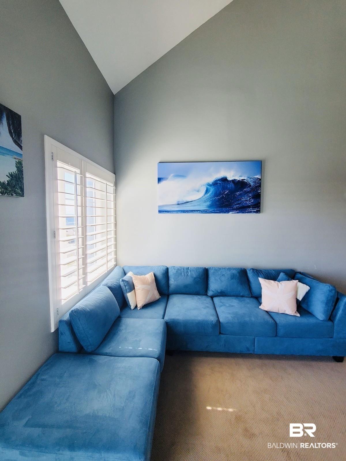 Image 4: Living room featuring carpet flooring and high vaulted ceiling