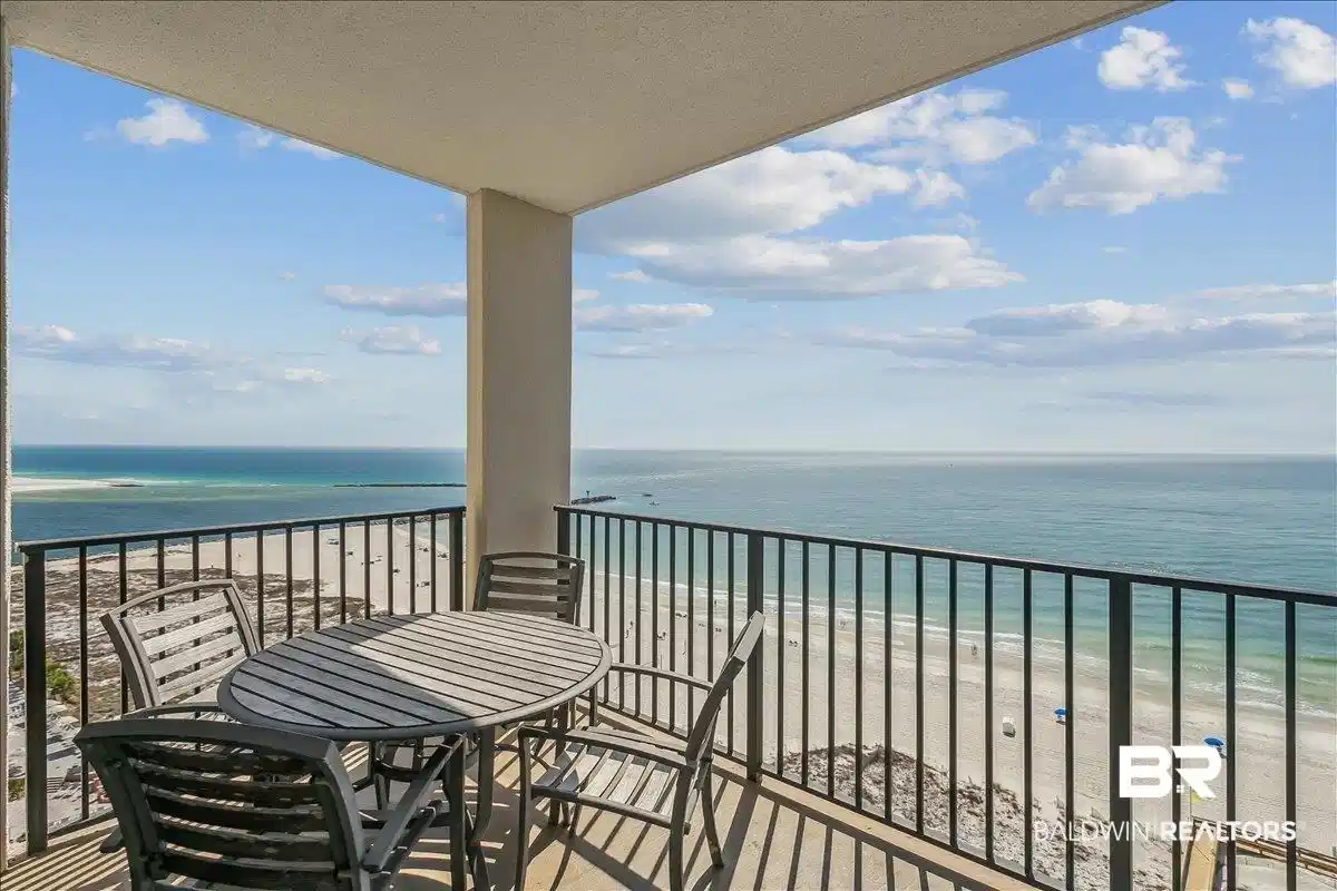 Image 1: Balcony with view of water and beach