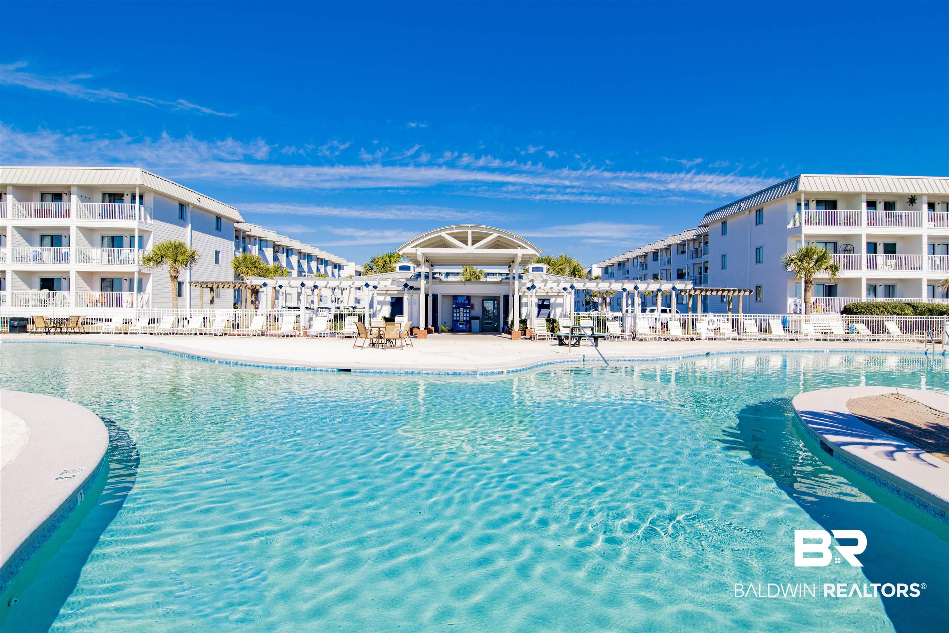 Image 3: Community pool featuring a patio area