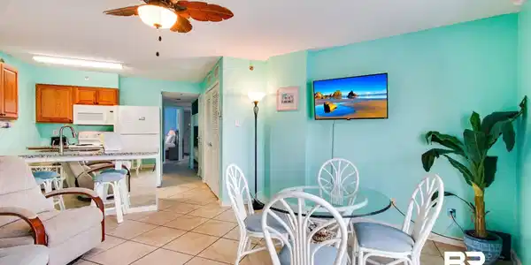 Image 4: Dining area featuring light tile patterned floors and a ceiling fan