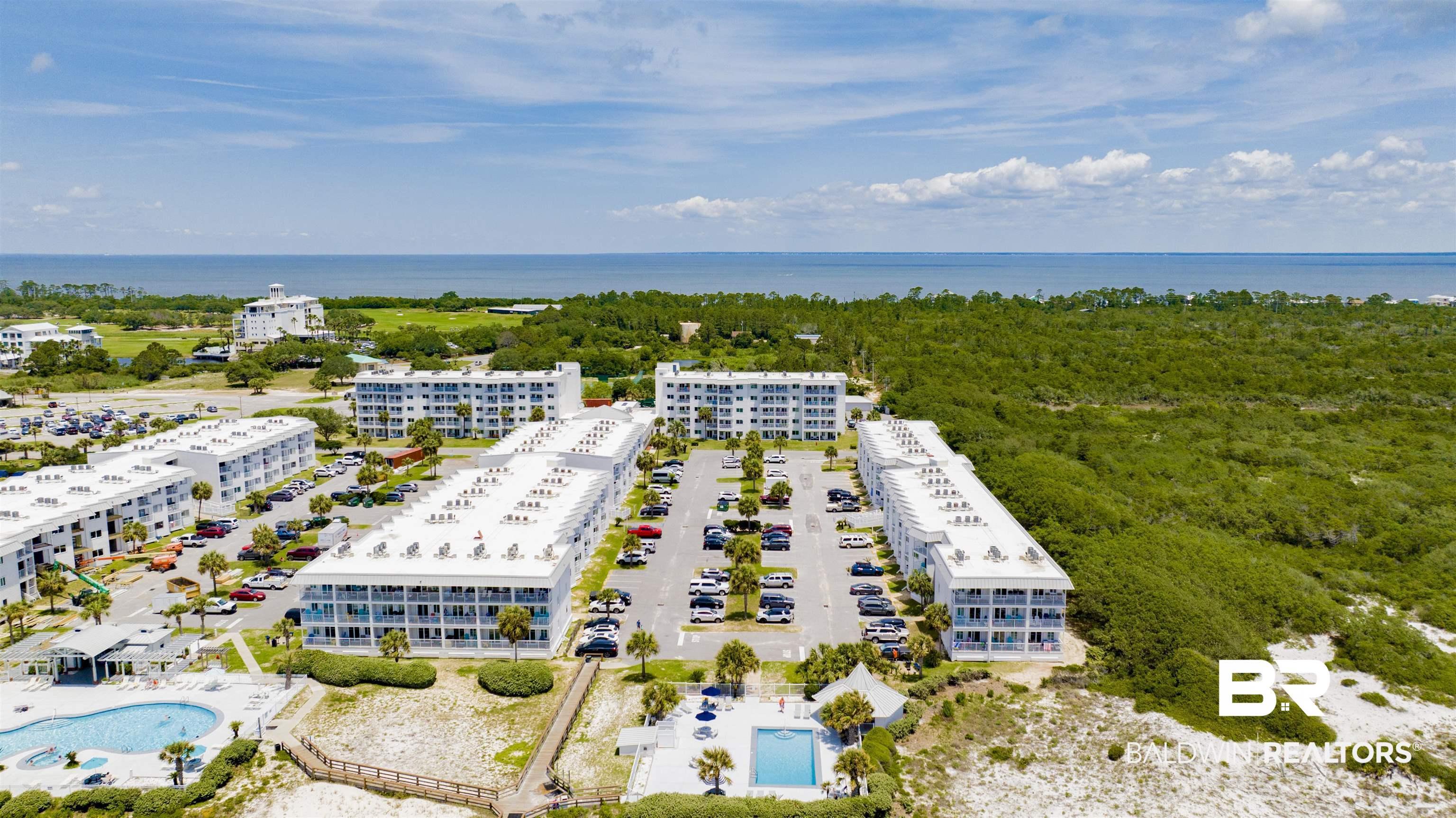 Image 4: Drone / aerial view of a pool area and a nearby body of water