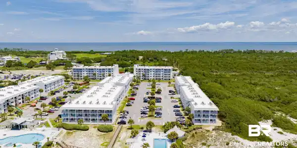 Image 4: Drone / aerial view of a pool area and a nearby body of water