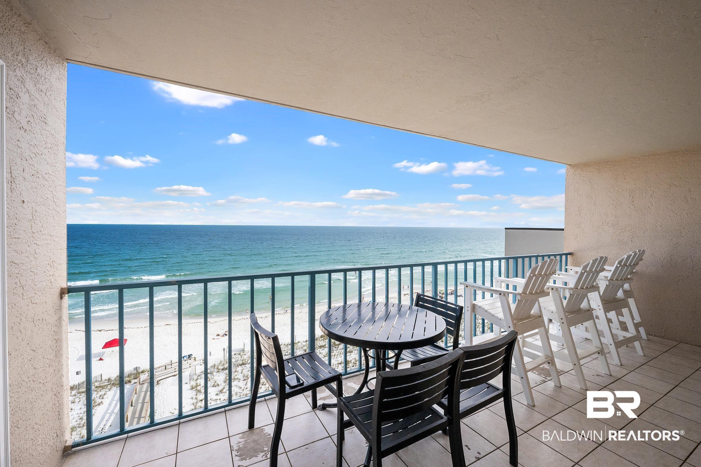 Image 2: Spacious balcony with tiled flooring and direct beachfront exposure