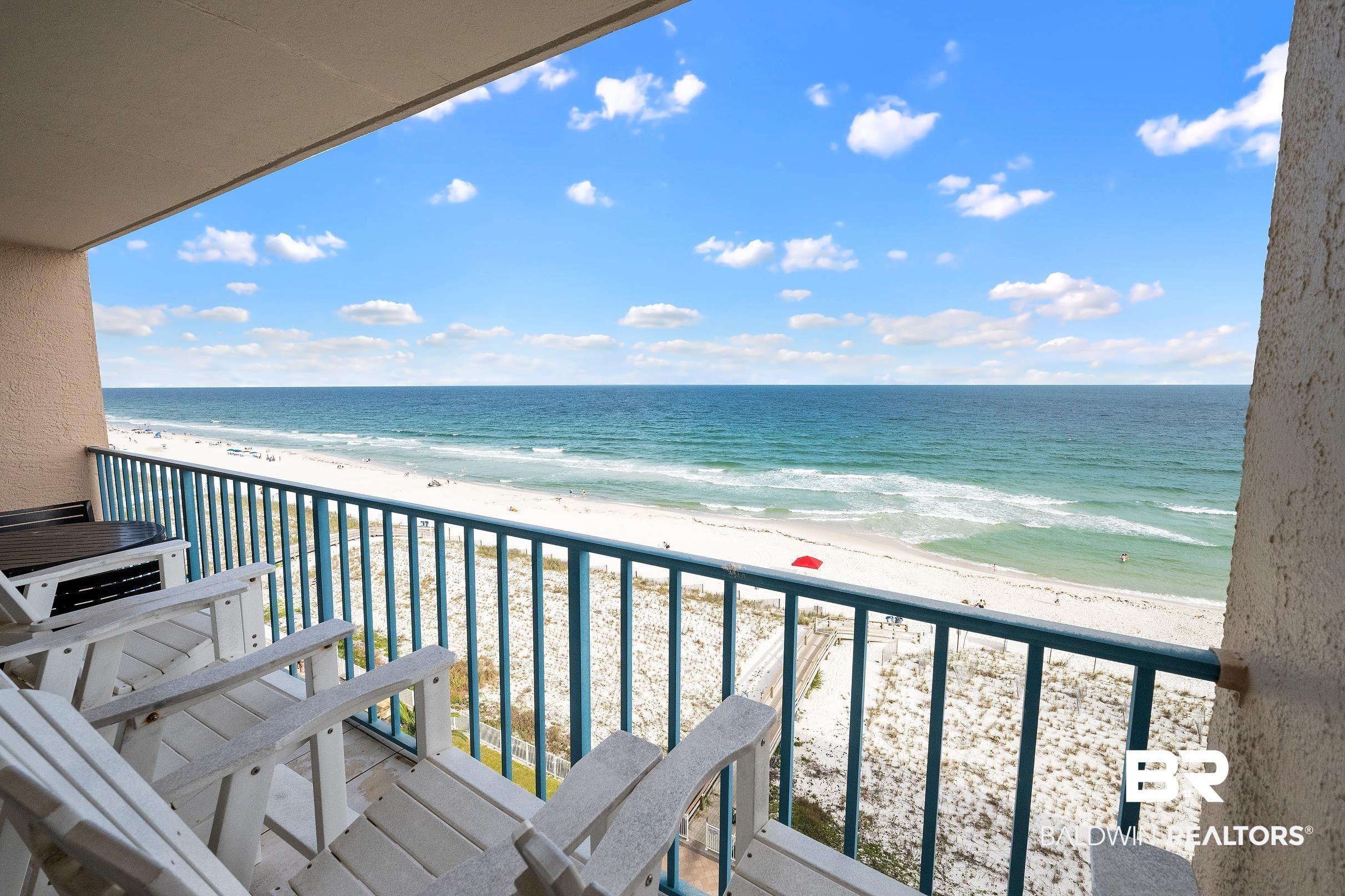 Image 3: Spacious balcony featuring a turquoise railing, direct beach access, white sand, and ocean waters