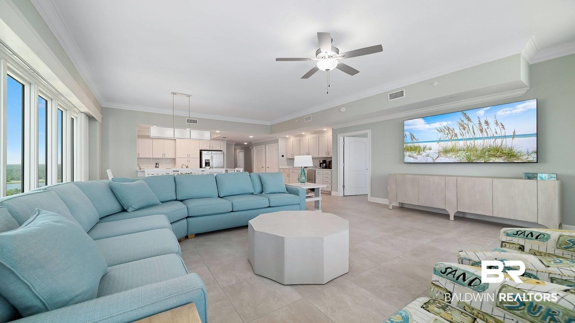 Image 3: Living room featuring crown molding, ceiling fan, and light tile patterned floors