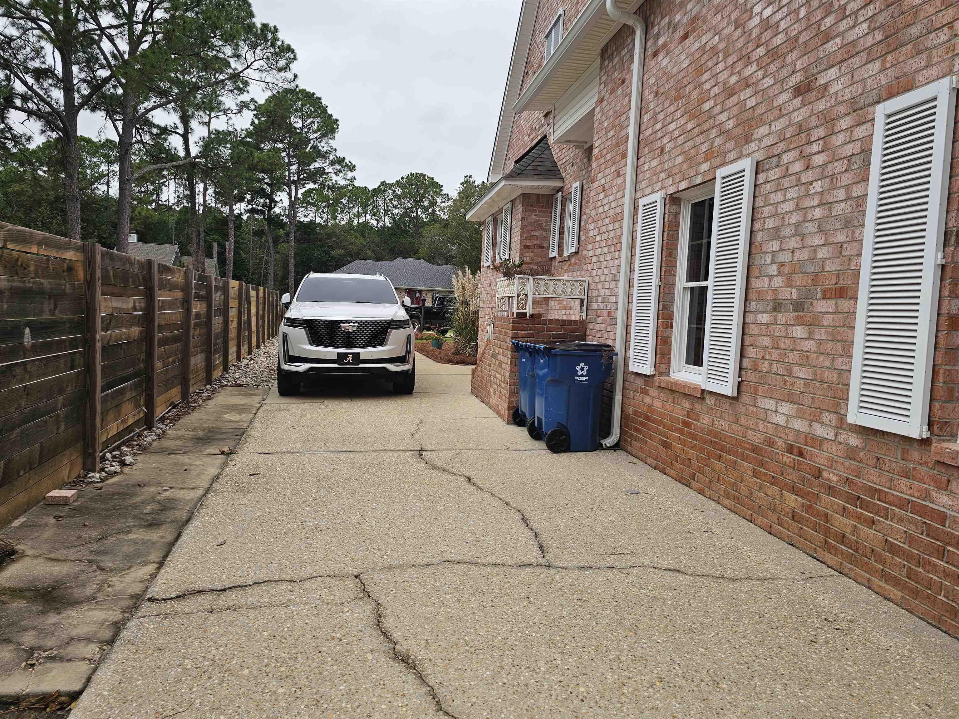 Image 4: View of vehicle parking featuring concrete driveway