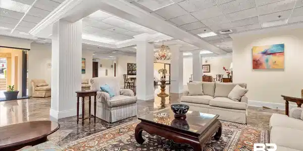 Image 2: The lobby features a wide-open foyer with living room area. Marble Floors and beautiful decor.
