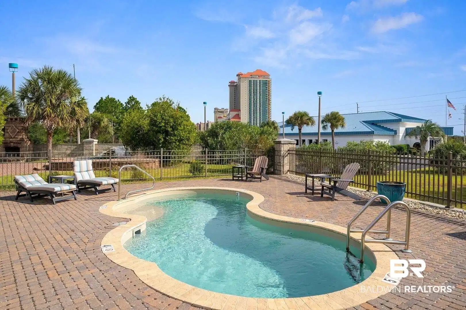 Image 1: View of pool featuring a patio area