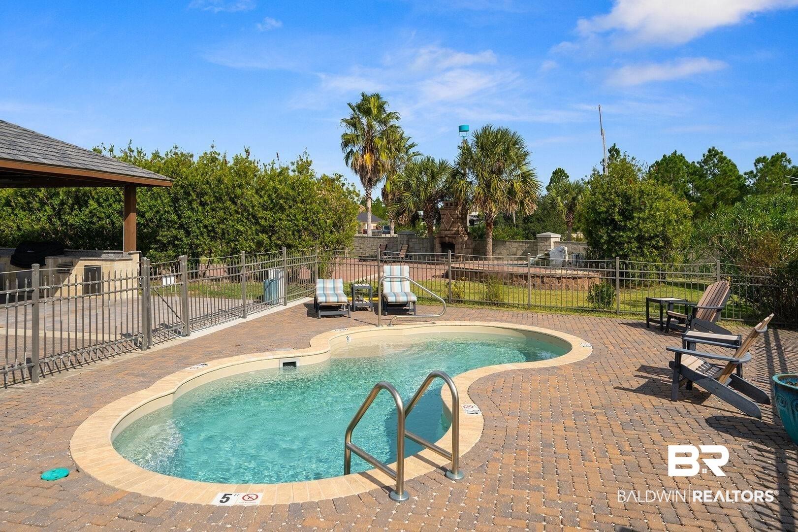 Image 4: View of pool featuring a patio area and a gazebo