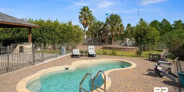 Image 4: View of pool featuring a patio area and a gazebo