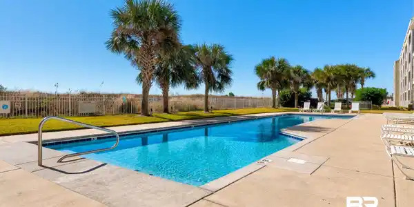 Image 3: Community pool featuring a patio