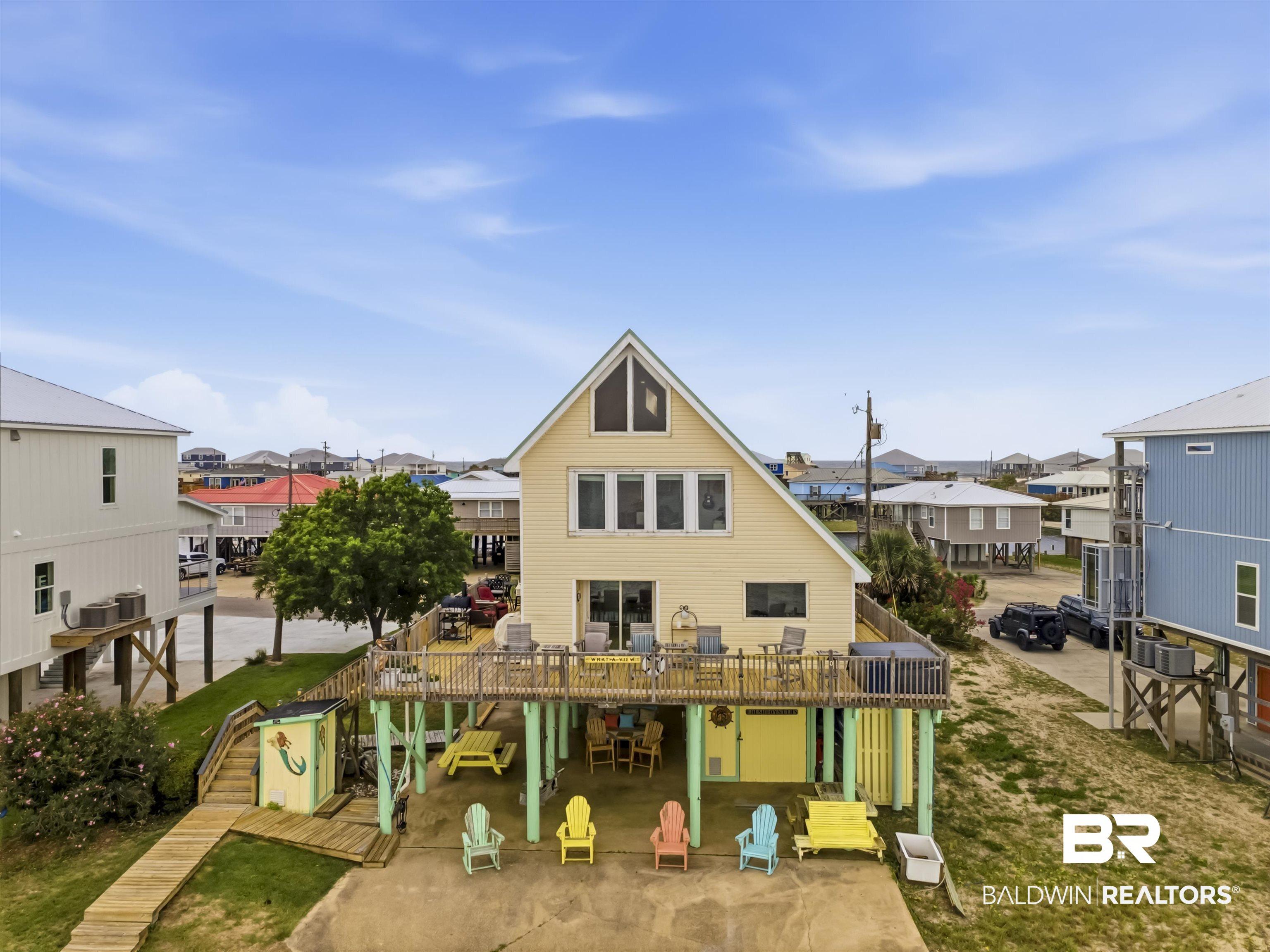 Image 2: Elevated coastal residence featuring a prominent A-frame architectural style and a spacious outdoor deck