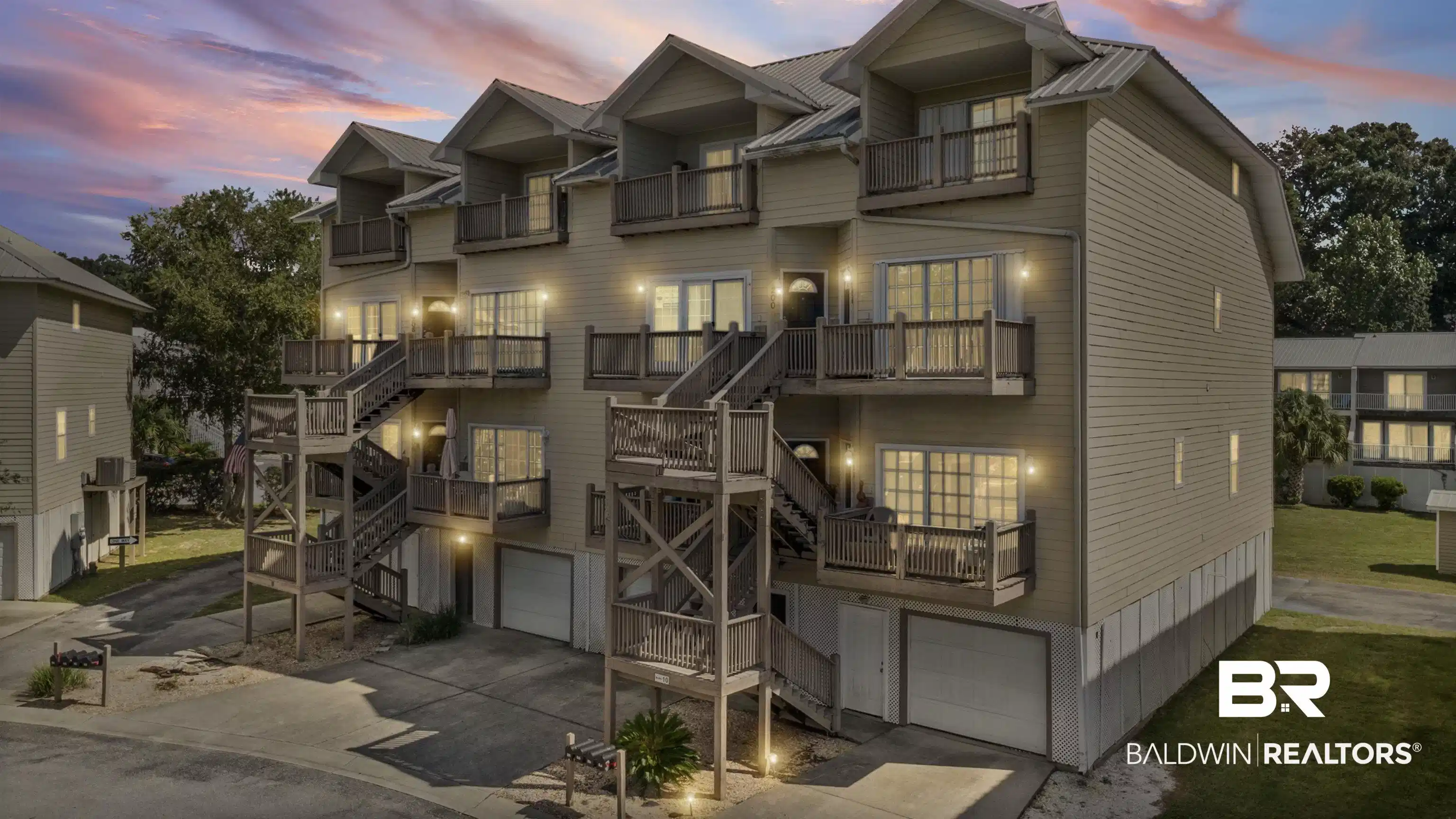 Image 1: Traditional-style home featuring stairway, an attached garage, concrete driveway, and a balcony