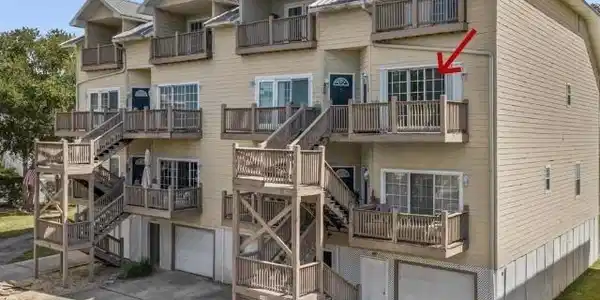 Image 2: View of property with stairs, an attached garage, and concrete driveway