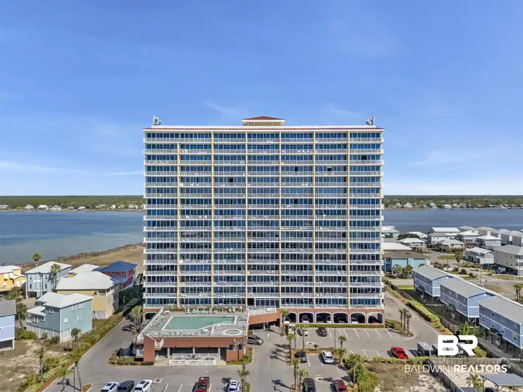 Image 1: View of building exterior with a water view