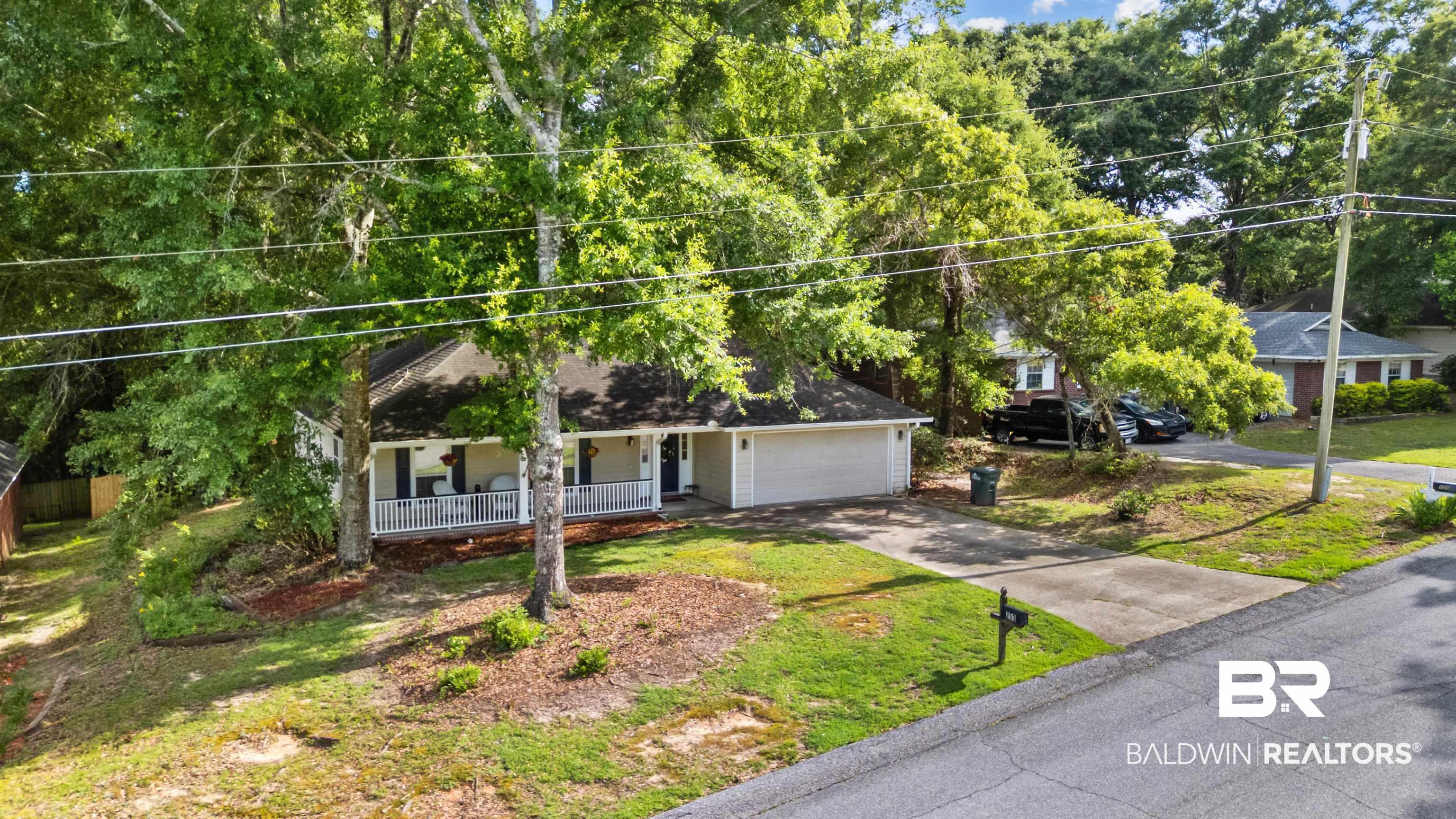 Image 4: Thoughtfully positioned among mature landscaping, this home blends privacy, comfort, and neighborhood charm.