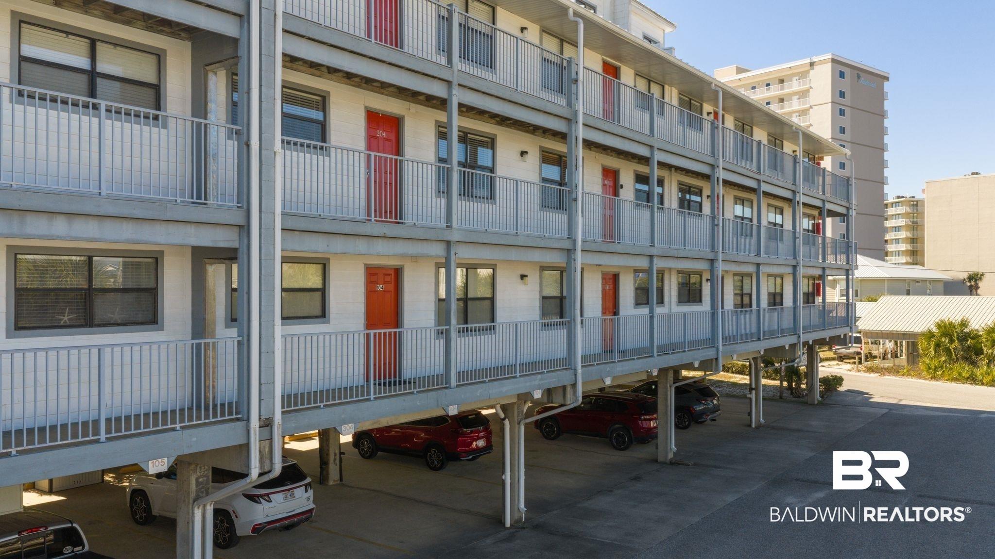 Image 2: View of apartment building / complex featuring covered parking