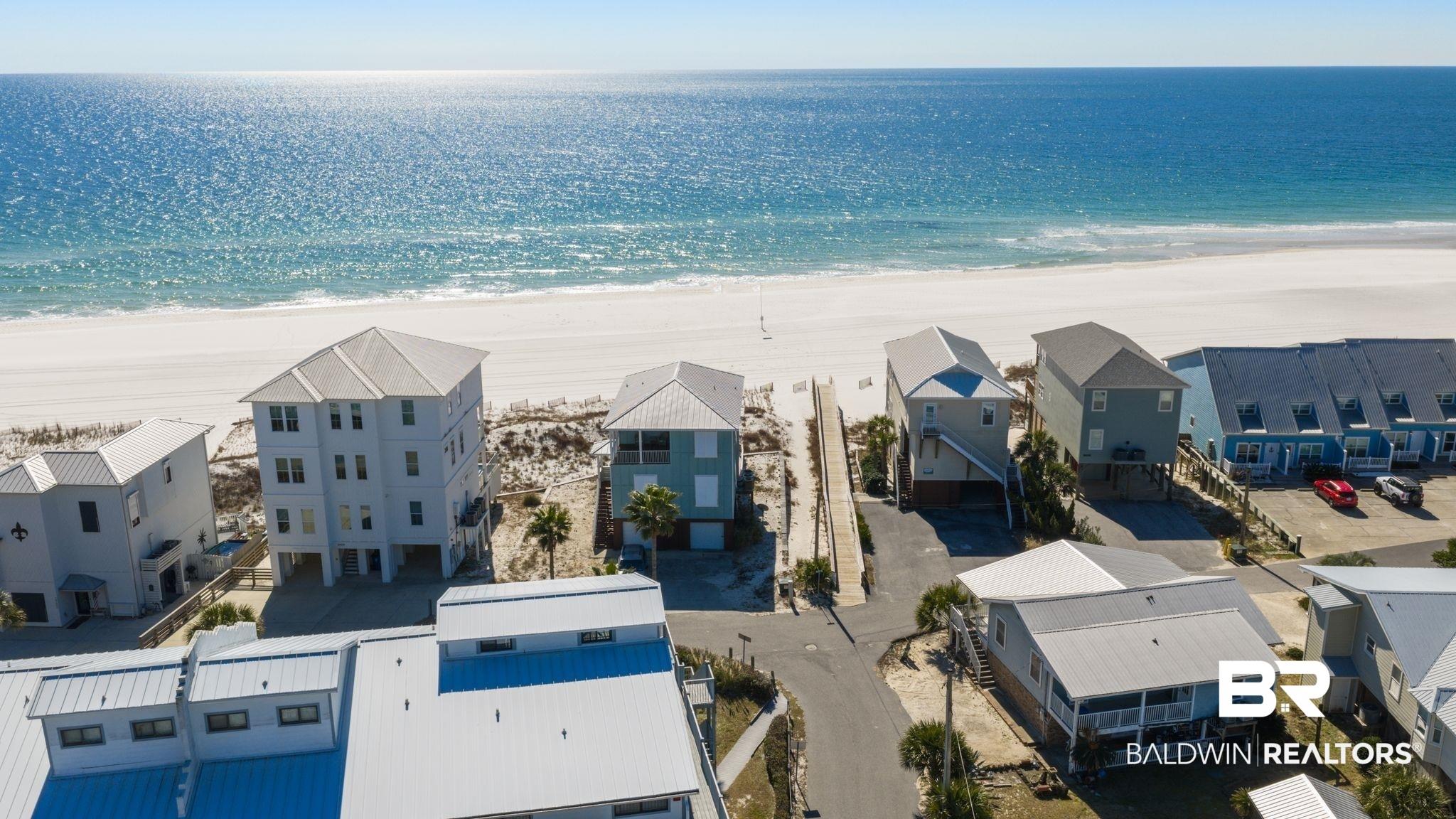Image 4: Aerial view of residential area featuring unending shoreline