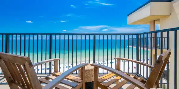 Image 3: Private balcony with a metal railing, concrete flooring, and direct oceanfront exposure