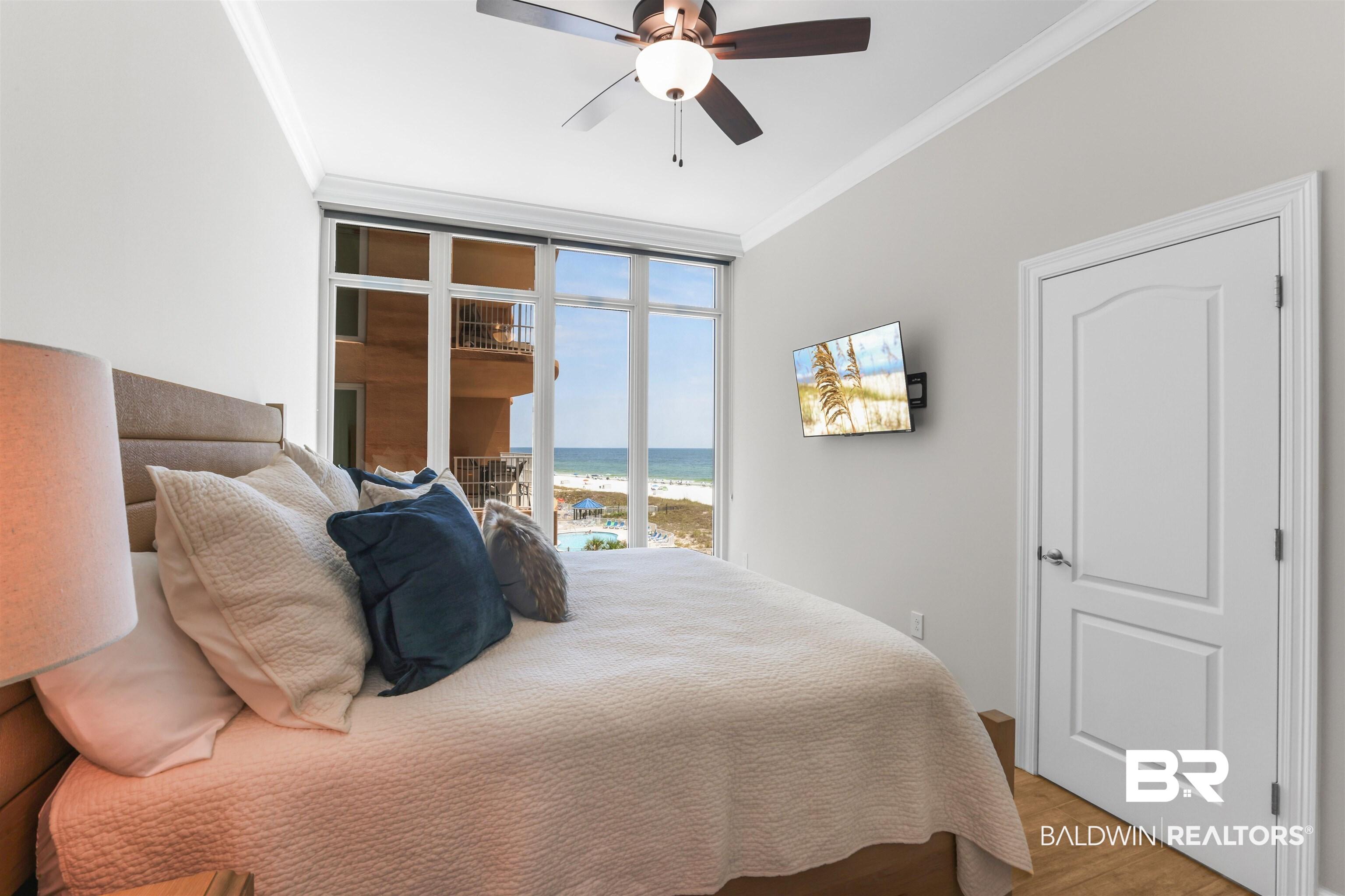 Image 4: Bedroom with crown molding, wood finished floors, and a ceiling fan