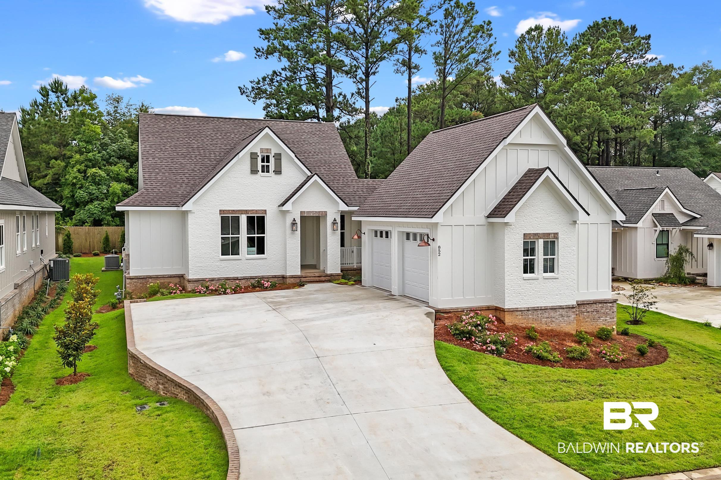 Image 2: Contemporary residence featuring white painted brick and board-and-batten siding