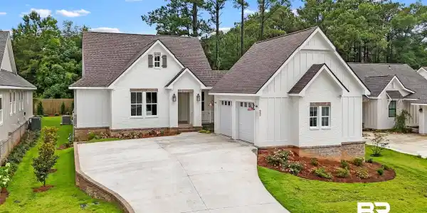 Image 2: Contemporary residence featuring white painted brick and board-and-batten siding
