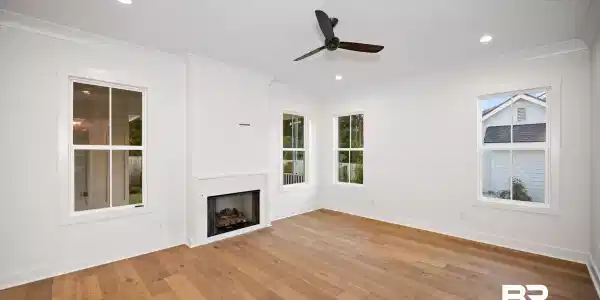 Image 3: Spacious room featuring wide plank wood-finish flooring