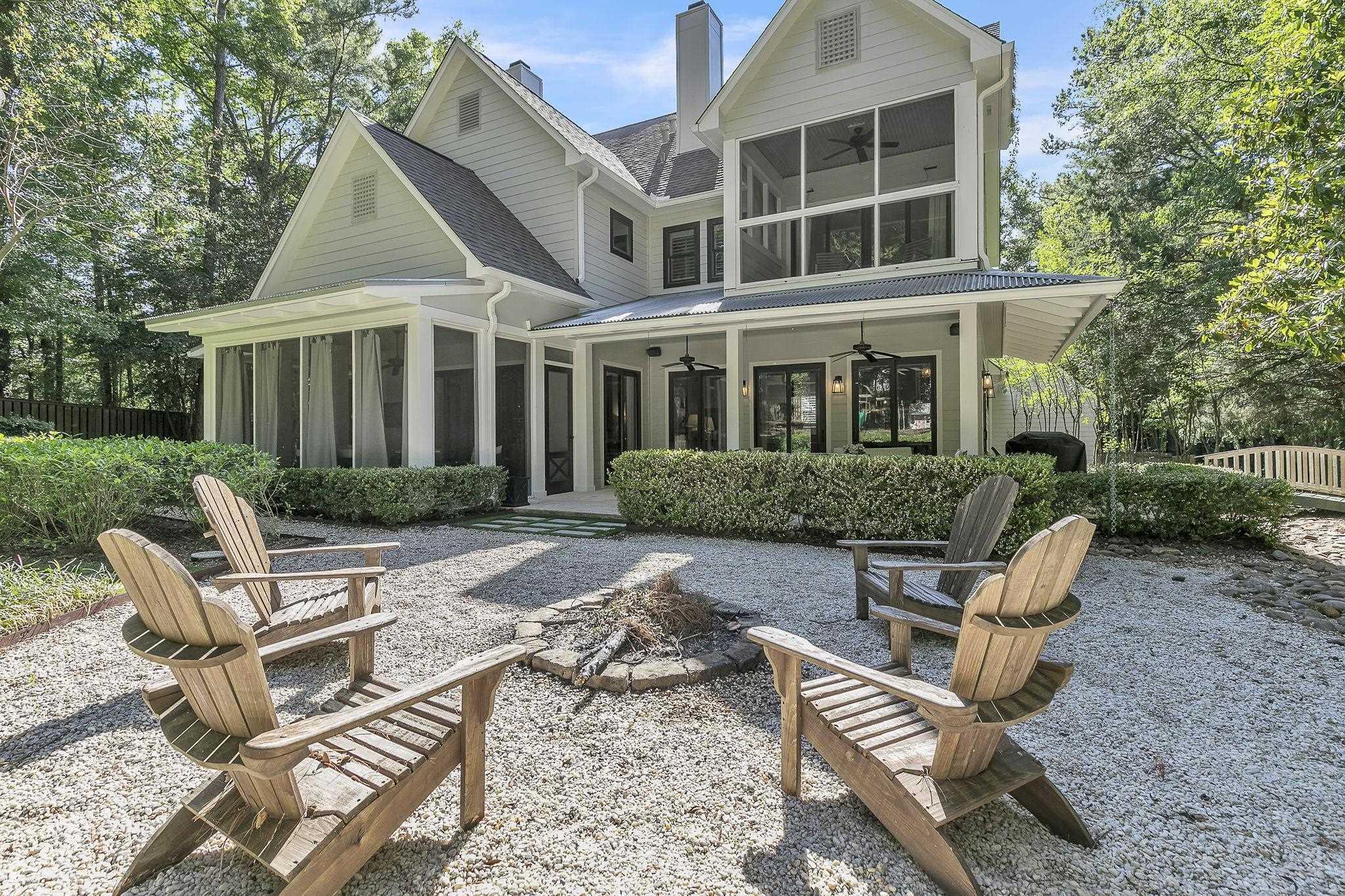 Image 1: Back of house with fence, a ceiling fan, a chimney, and a sunroom