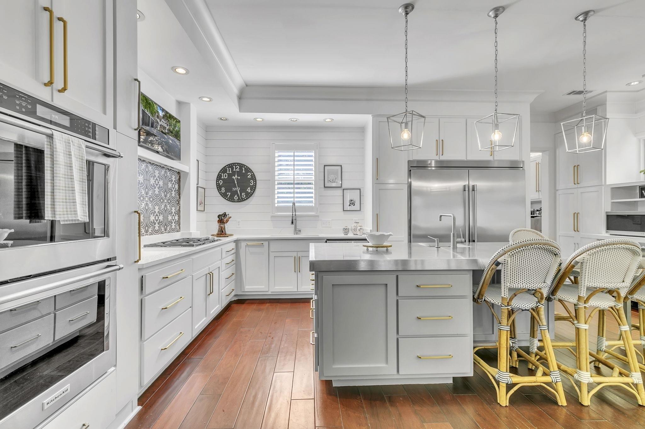 Image 4: Kitchen featuring backsplash, appliances with stainless steel finishes, a sink, and light countertops