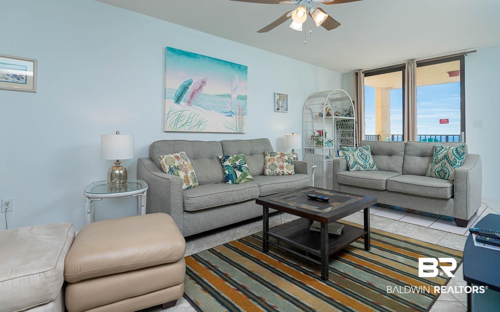 Image 2: Tiled living room with a ceiling fan