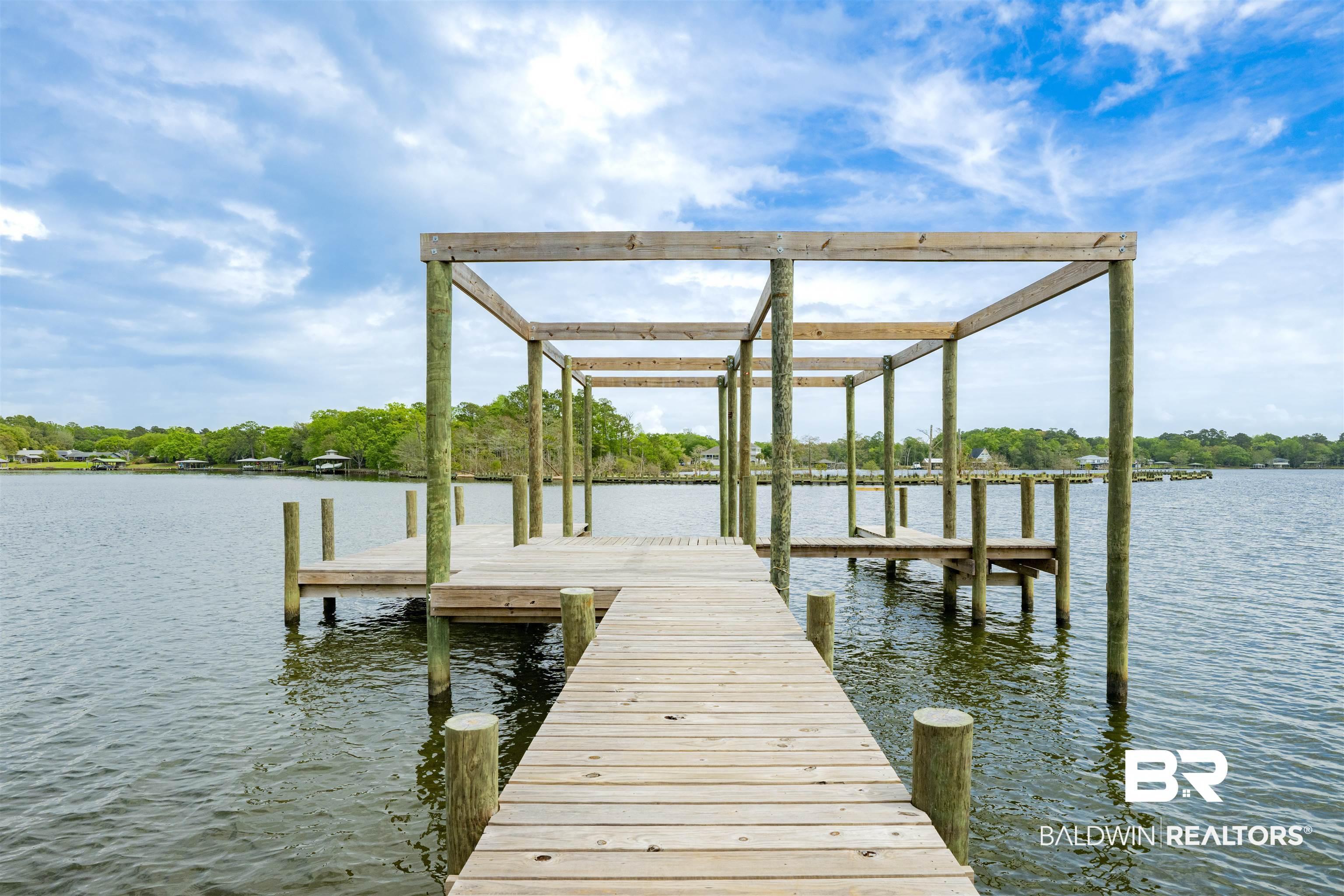 Image 1: Dock featuring a water view