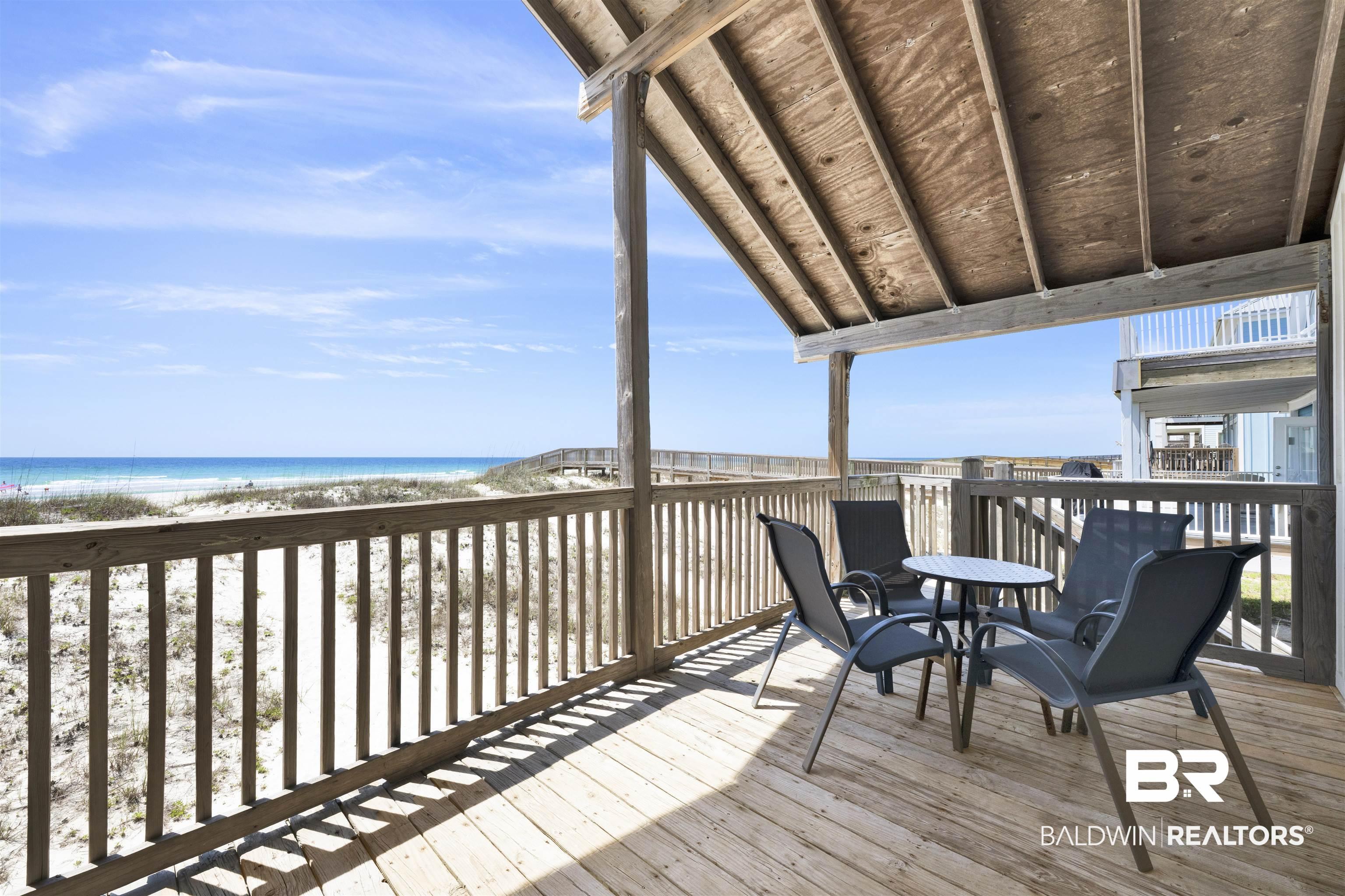 Image 2: Expansive outdoor deck featuring wood flooring and a slatted wood railing