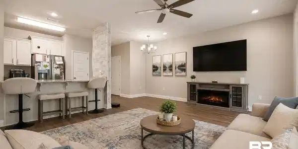 Image 4: Open-concept living space featuring wood-finish flooring, recessed lighting, and a ceiling fan
