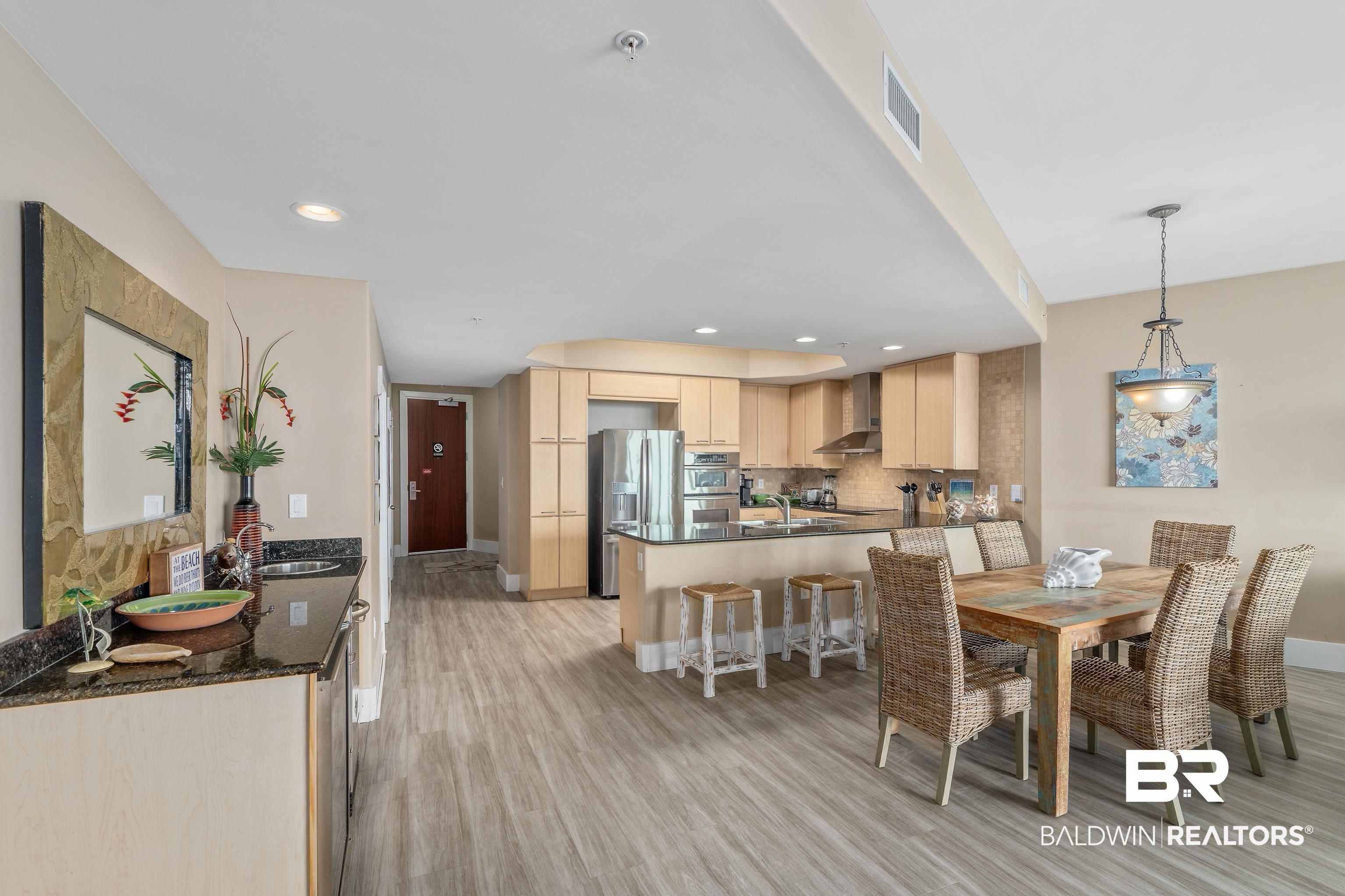 Image 3: Dining area with light hardwood / wood-style floors and sink