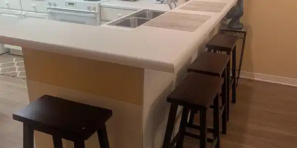 Image 3: Kitchen with a breakfast bar area.