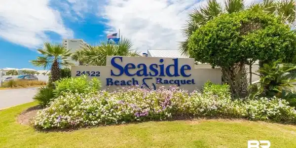 Image 2: Entryway signage featuring a concrete base with raised lettering, surrounded by manicured landscaping