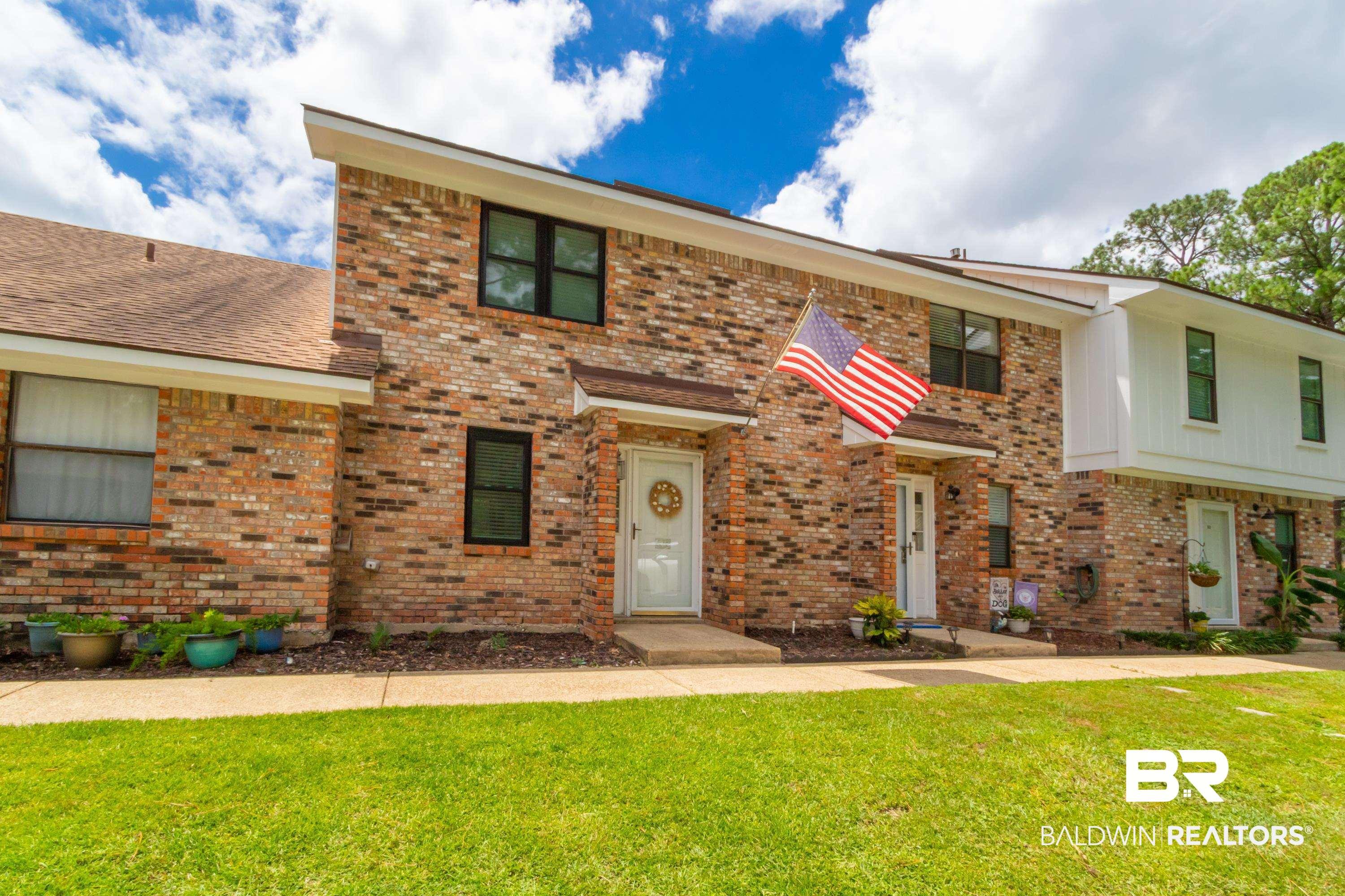 Image 4: Brick exterior with contrasting white trim and dark-framed windows