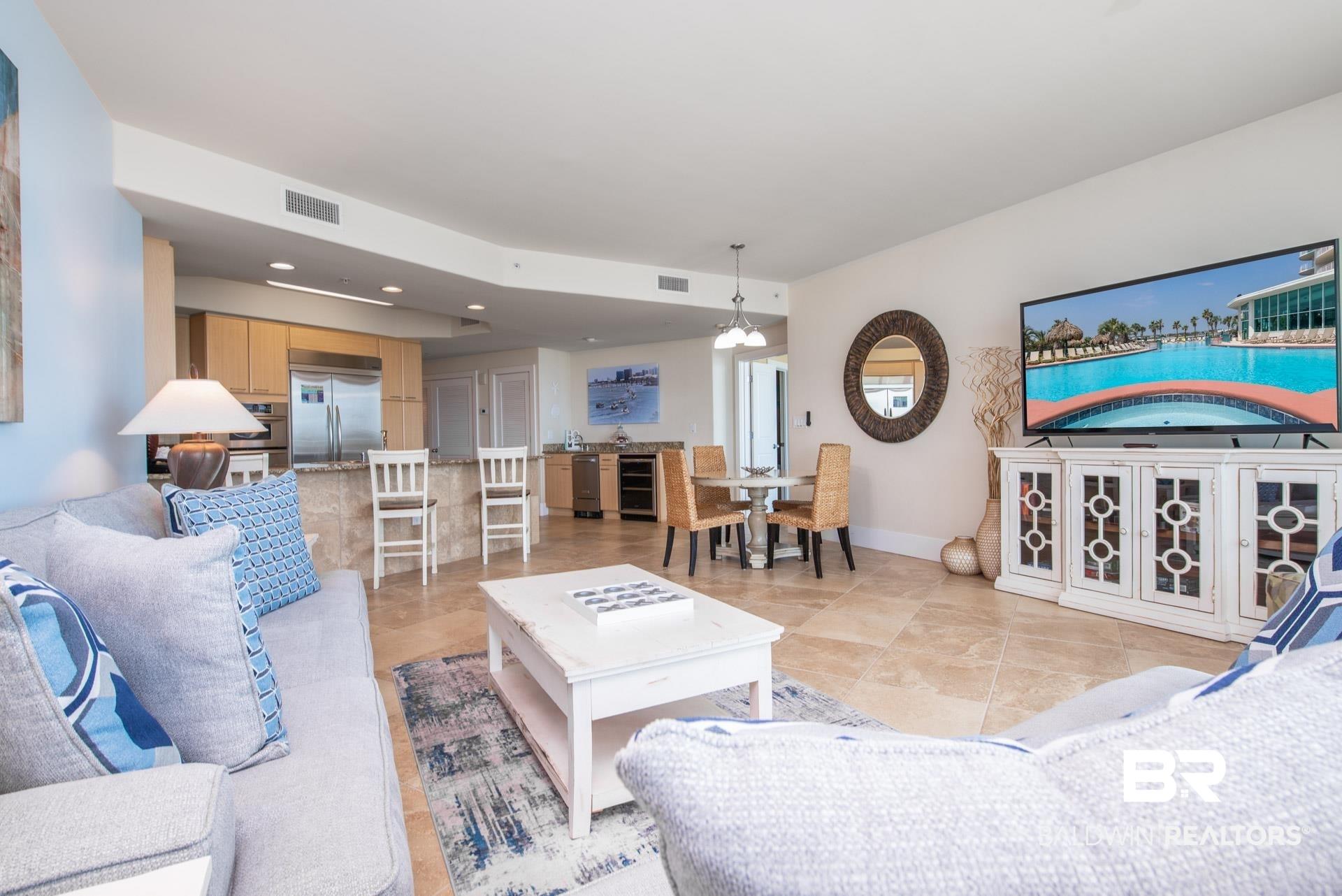 Image 3: Living area with wine cooler, baseboards, and recessed lighting