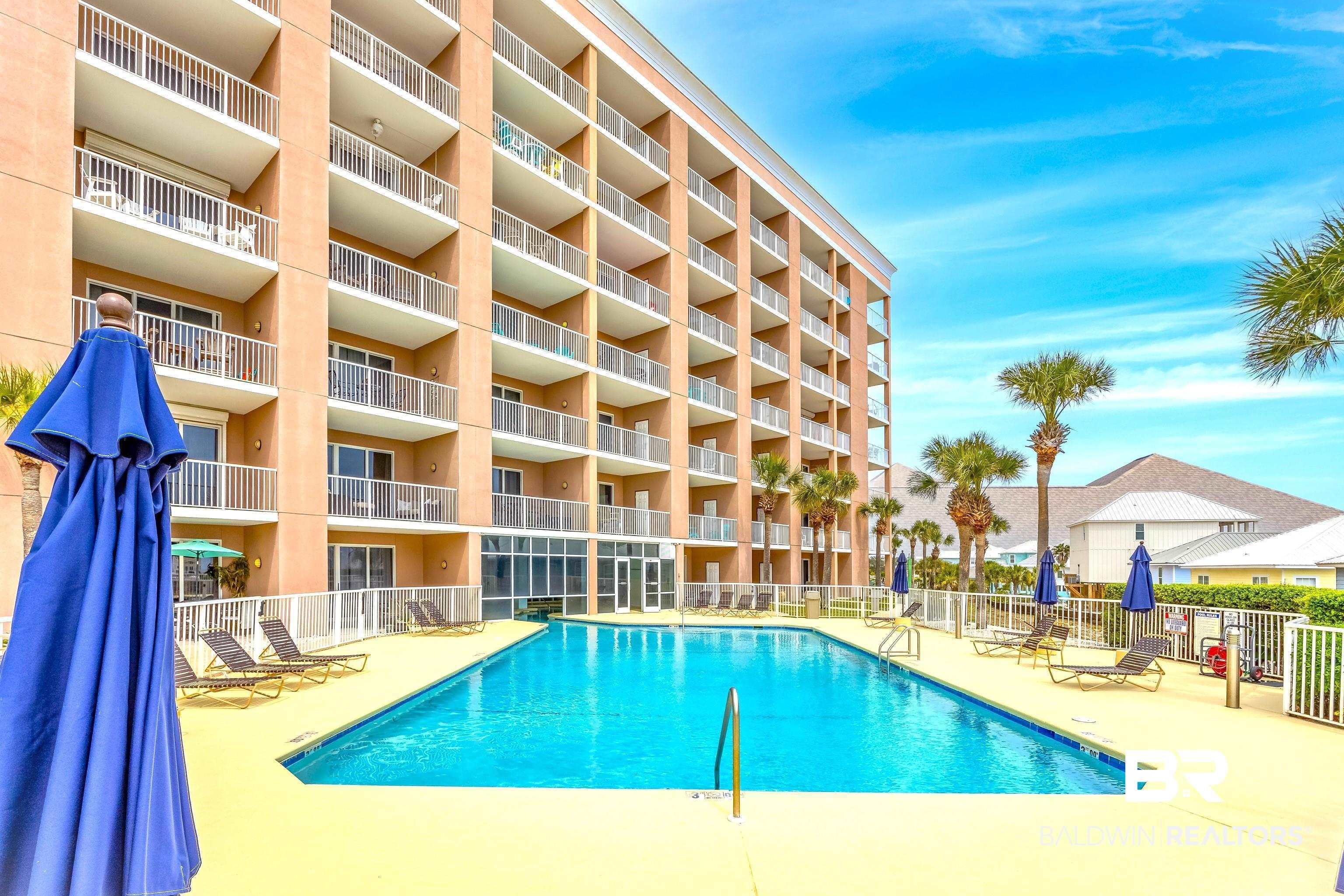 Image 2: Community pool featuring a patio area