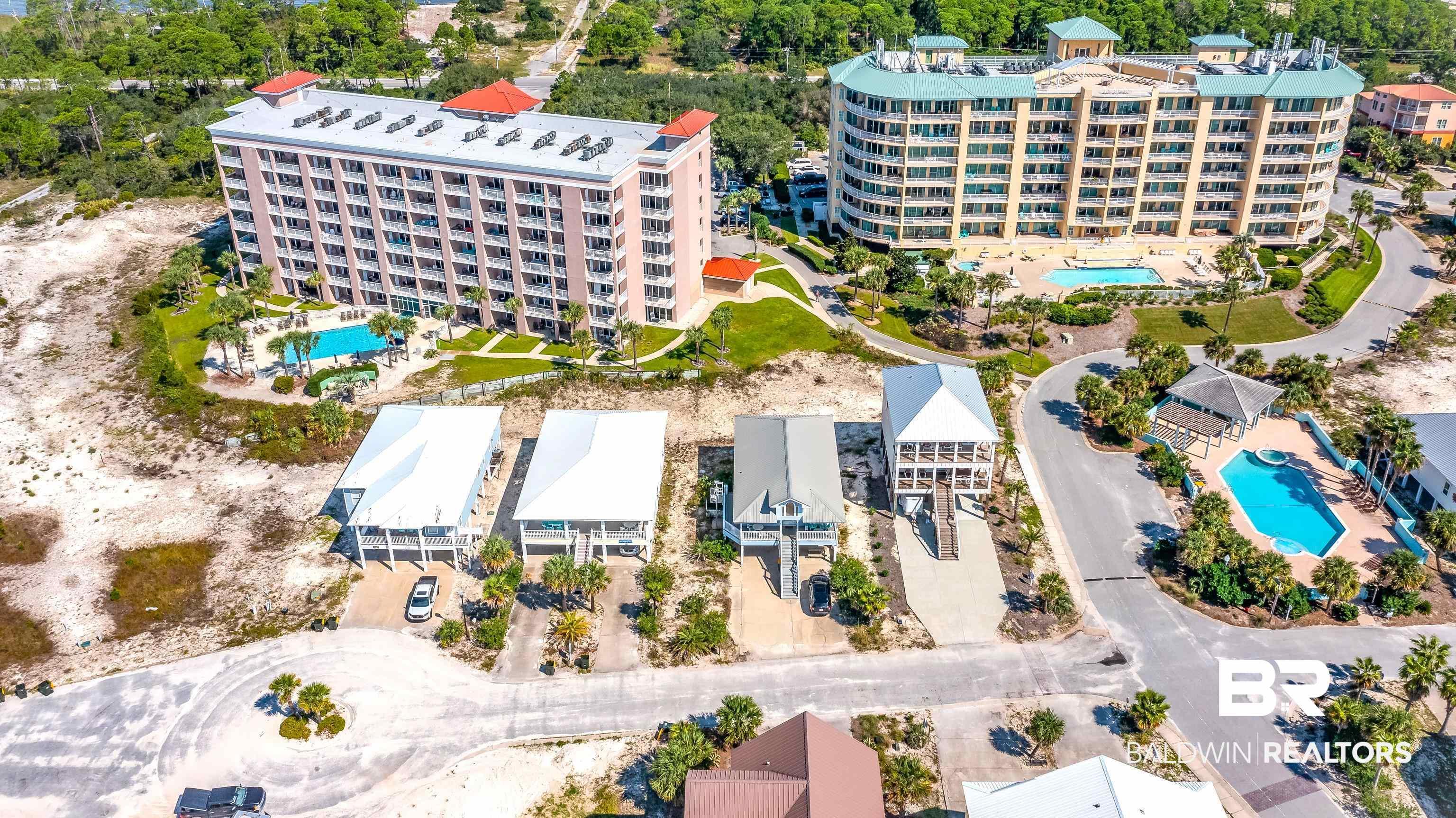 Image 4: Aerial view of a pool area and apartment complex