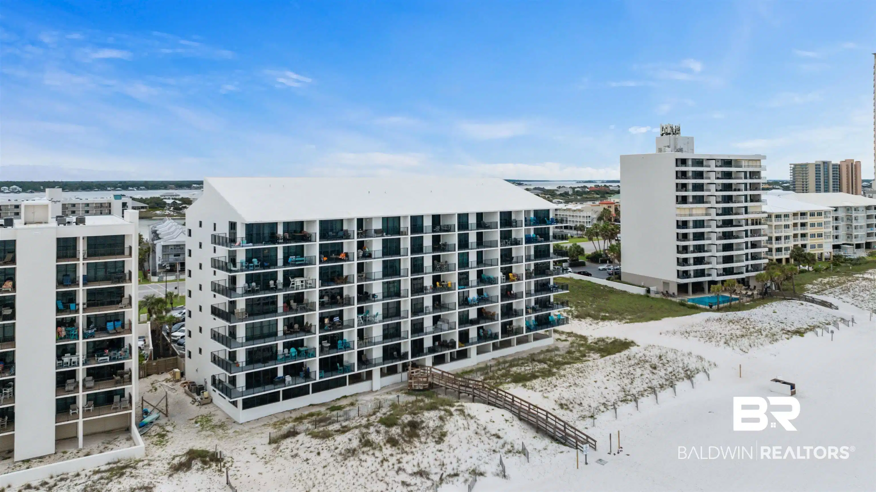 Image 1: Beachfront condominium complex featuring multiple stories of private balconies