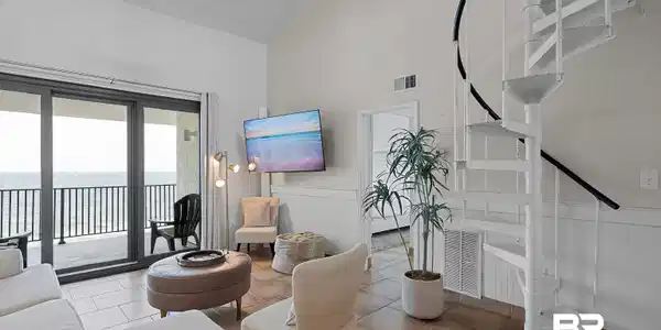 Image 3: Living area featuring a spiral staircase, vaulted ceilings, and tile flooring