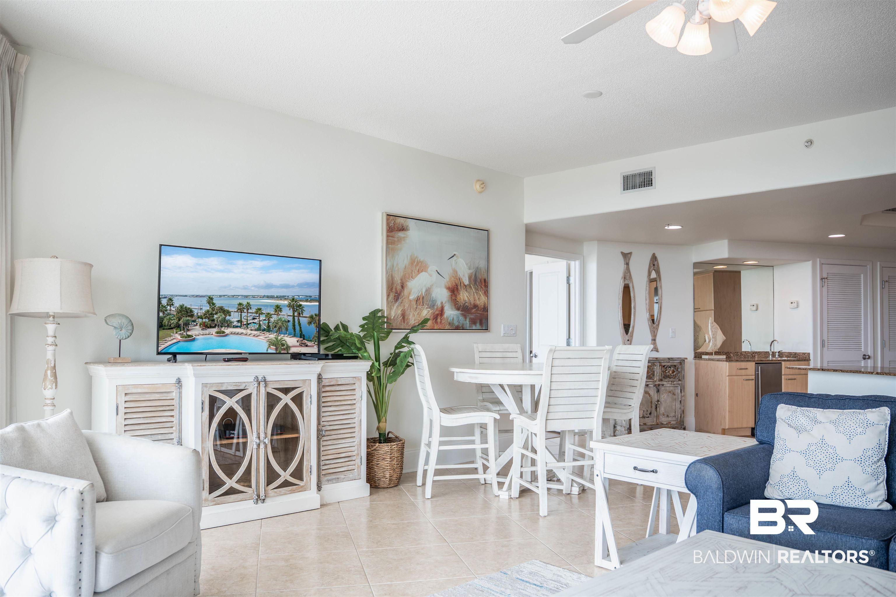 Image 3: Living room with tile patterned flooring, a ceiling fan, and recessed lighting