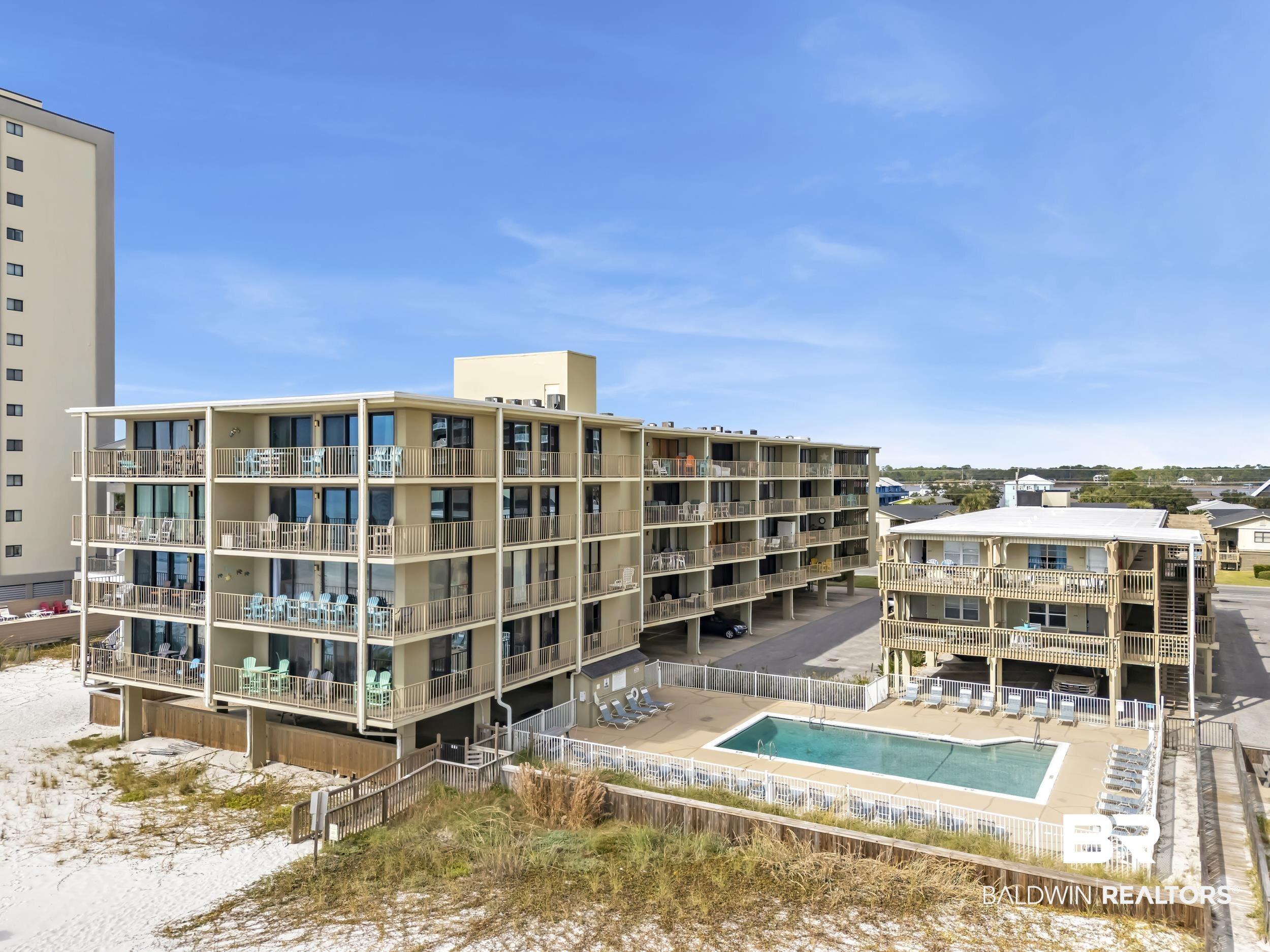 Image 4: View of apartment building / complex with a community pool