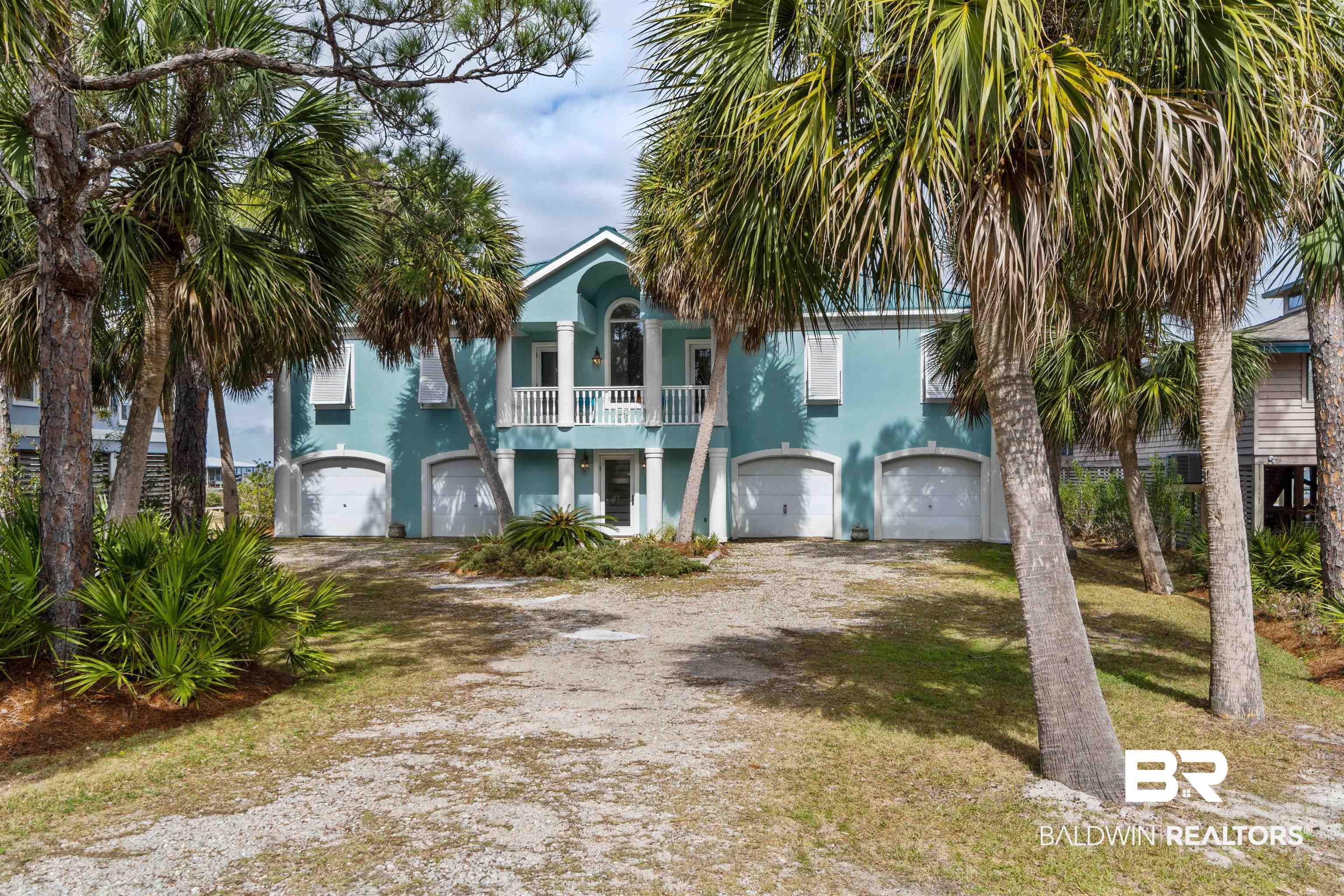 Image 2: View of front facade featuring stucco siding, an attached garage, and driveway