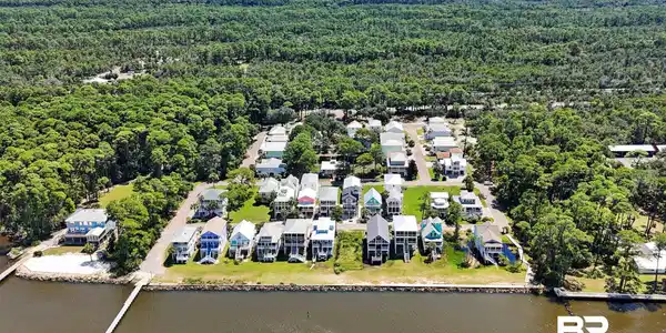 Image 4: Aerial perspective of suburban area with a nearby body of water