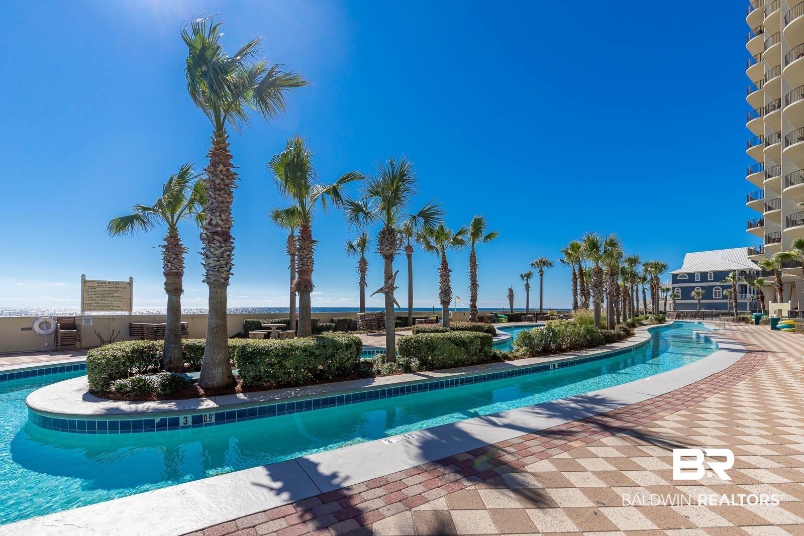 Image 2: Community pool with a patio area