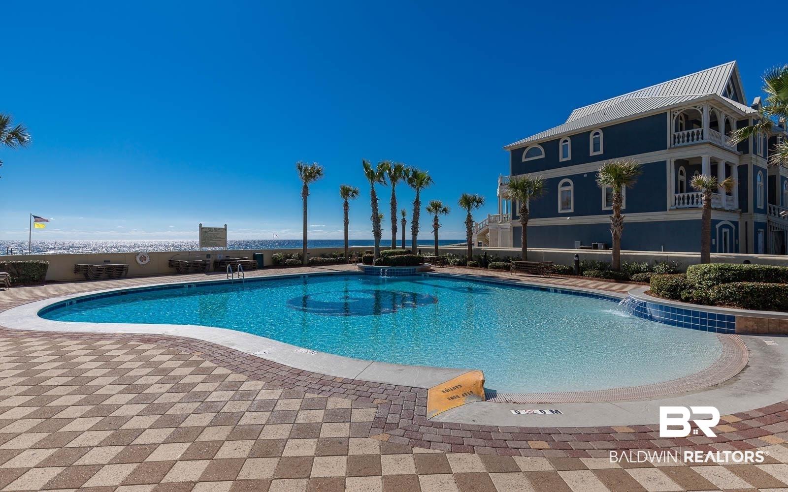 Image 3: Community pool featuring a patio